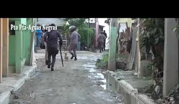 Policías salen huyendo durante una protesta callejera en un sector de Puerto Plata 
