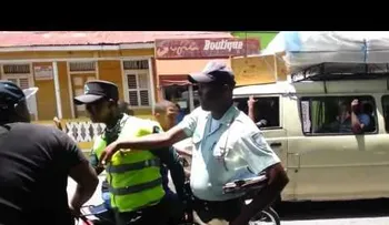 Un hombre le da un galletón a un agente de AMET