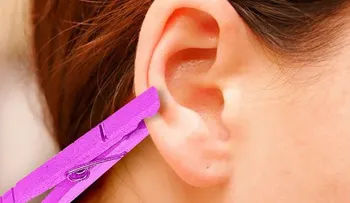 Aliviar el dolor rápido usando la oreja y una pinza de ropa