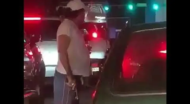 Un hombre saca su arma en medio de un tapón