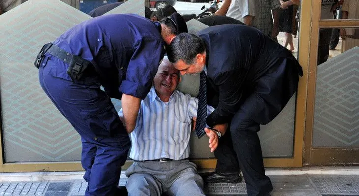 La foto que conmociona la Red: Un jubilado griego llora a las puertas de un banco