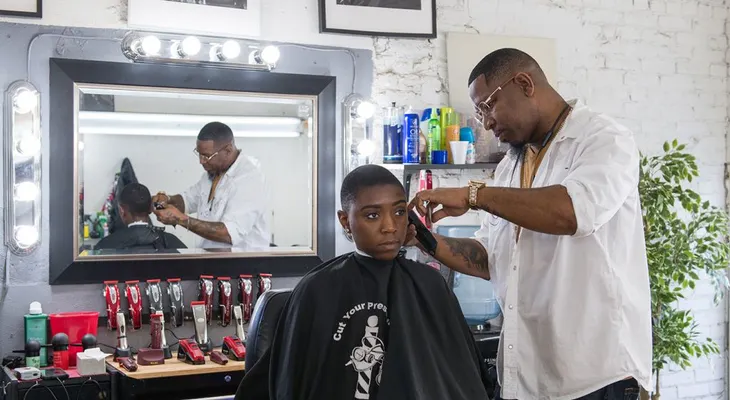 Barberos cortan el pelo de sus clientes y les ayudan a disminuir su presión arterial