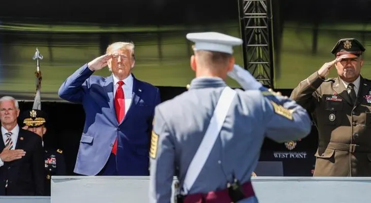 Trump promete "extinguir la plaga" del COVID-19 en un baño de masas militar